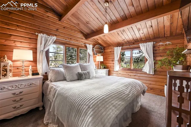 a bedroom with a bed a large window with outer view