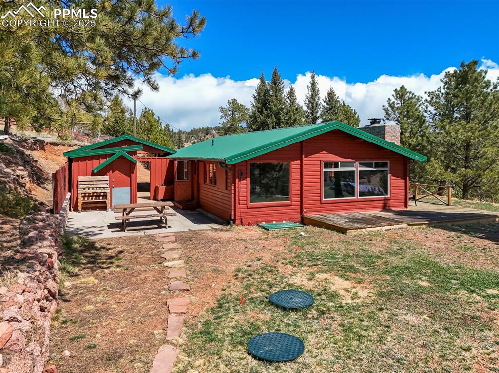 193 Independence Road Cripple Creek, CO 80813 - Photo 26 of 39 a view of a house with backyard and porch