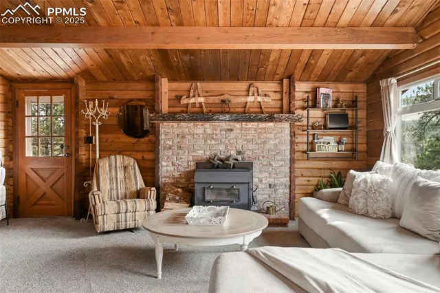 a living room with furniture a fireplace and a table