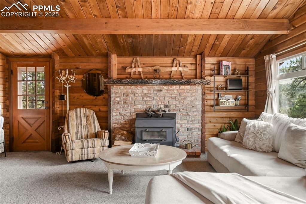 193 Independence Road Cripple Creek, CO 80813 - Photo 7 of 39 a living room with furniture a fireplace and a table