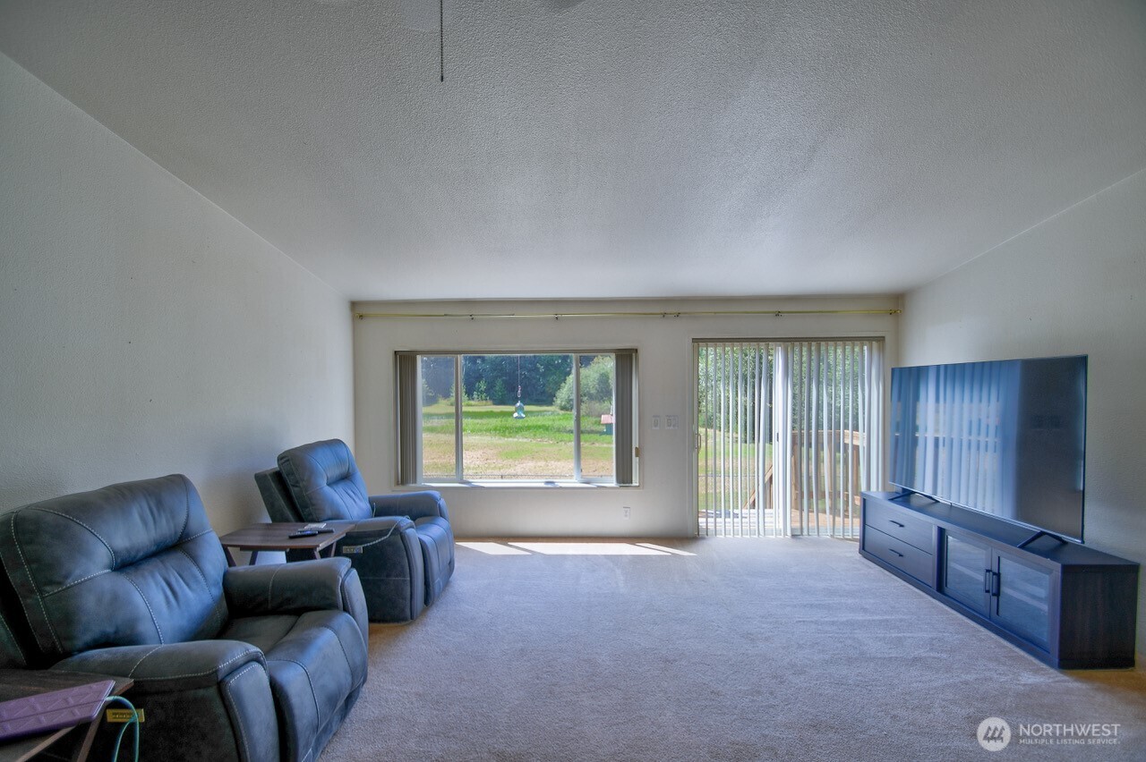 930 Tipsoo Loop North Rainier, WA 98576 - Photo 8 of 40 a living room with furniture and a flat screen tv