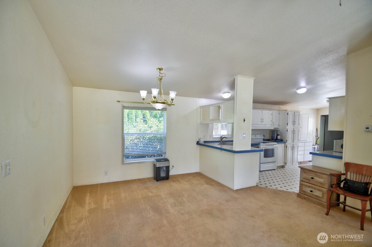 930 Tipsoo Loop North Rainier, WA 98576 - Photo 9 of 40 a kitchen with kitchen island granite countertop a sink counter top space and appliances