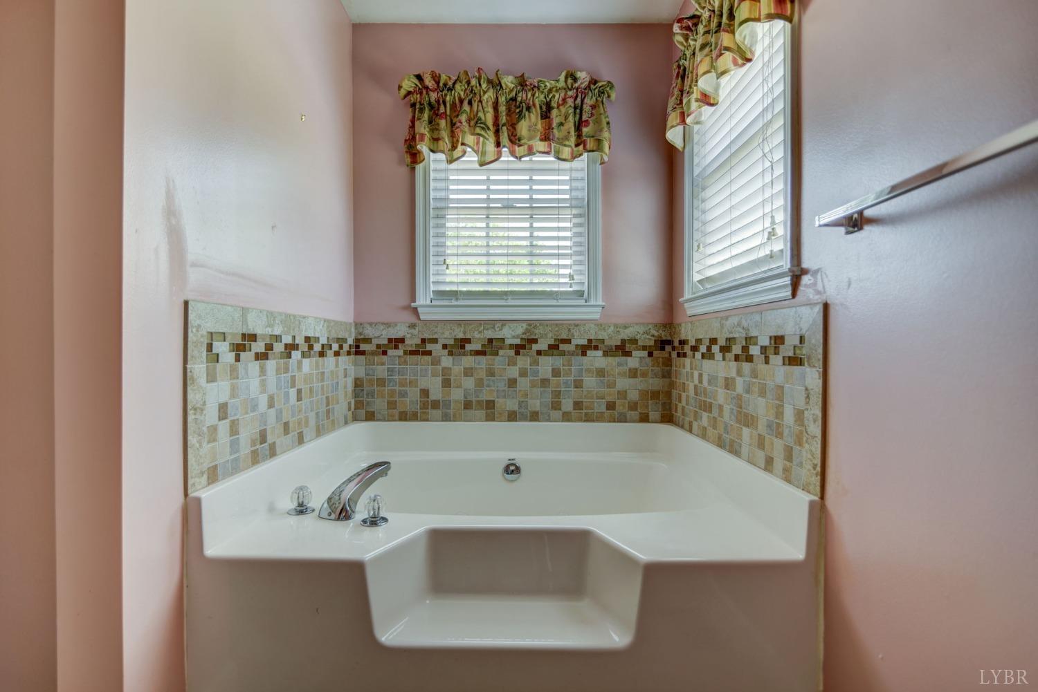 6835 Level Run Road Long Island, VA 24569 - Photo 23 of 57 a bath tub sitting in a bathroom next to a window