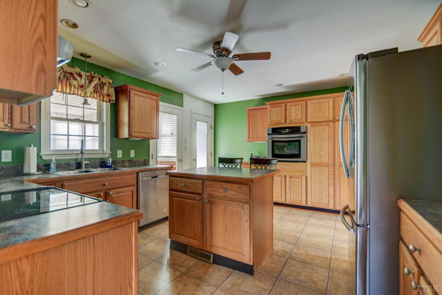 6835 Level Run Road Long Island, VA 24569 - Photo 8 of 57 a kitchen with a sink a counter top space cabinets stainless steel appliances and a window