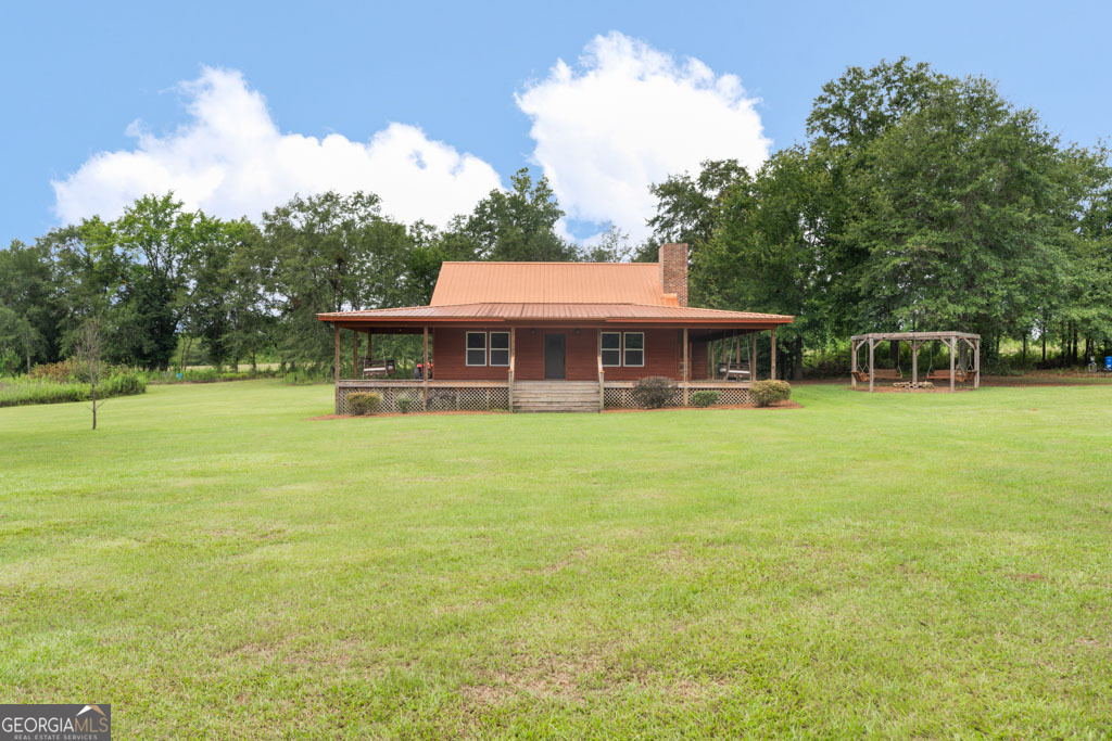 2093 Harts Ford Road Tennille, GA 31089 - Photo 1 of 1 a view of a house with a backyard