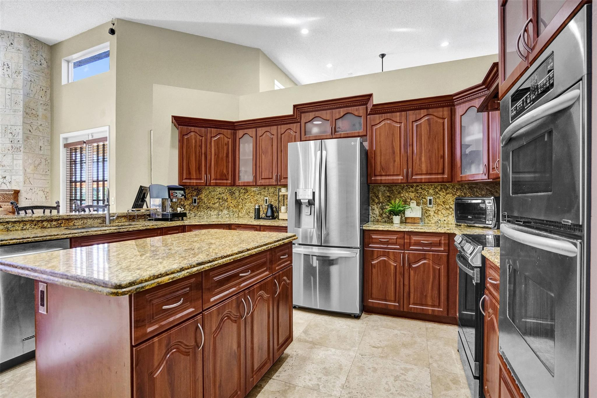 3151 Southwest 135th Terrace Davie, FL 33330 - Photo 17 of 74 a kitchen with stainless steel appliances granite countertop a refrigerator a stove and a sink