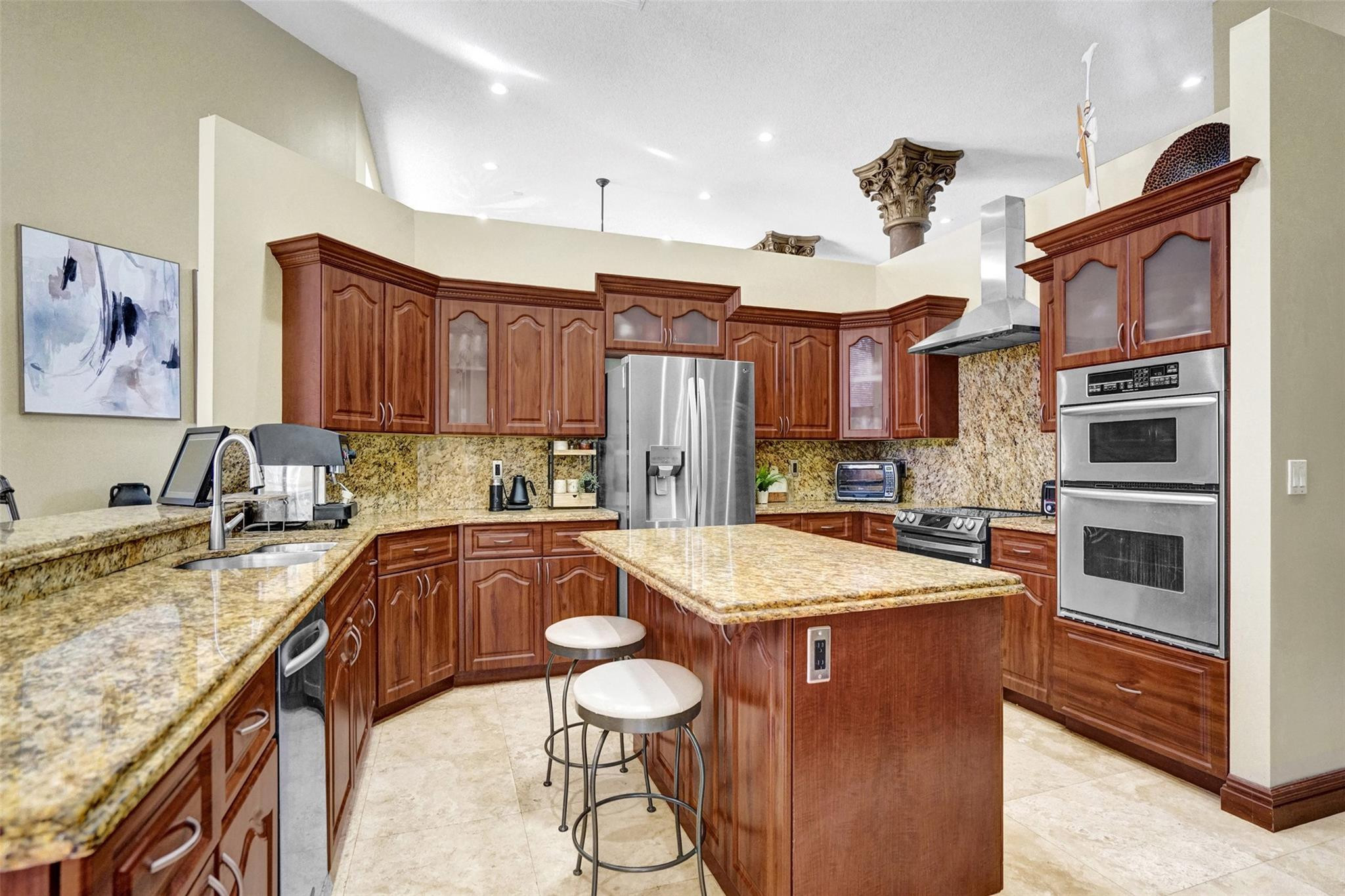 3151 Southwest 135th Terrace Davie, FL 33330 - Photo 20 of 74 a kitchen with stainless steel appliances granite countertop a sink stove and refrigerator