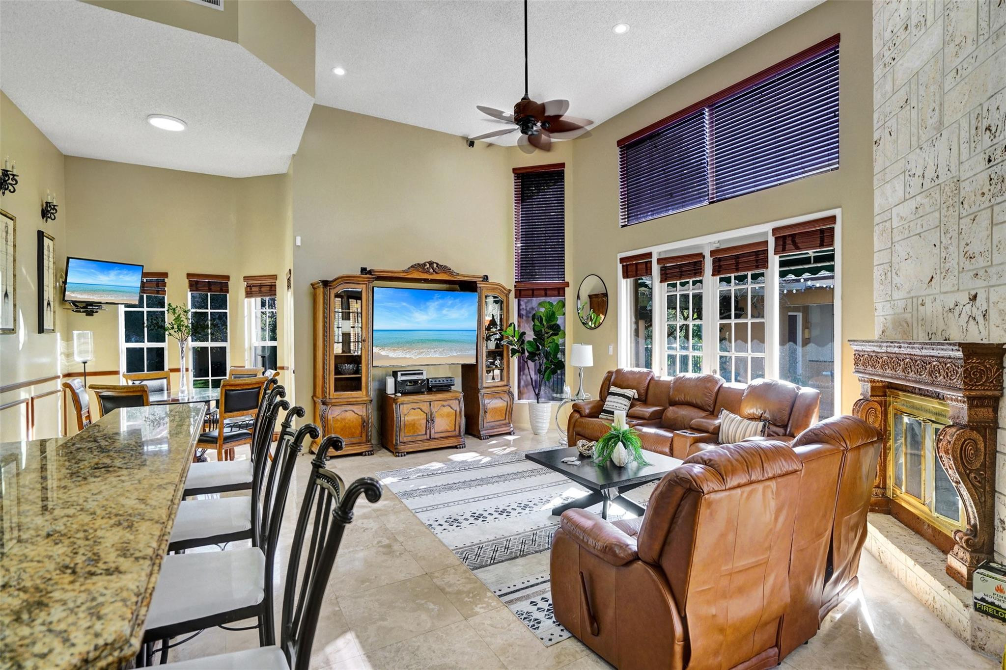 3151 Southwest 135th Terrace Davie, FL 33330 - Photo 24 of 74 a living room with furniture a fireplace and a flat screen tv