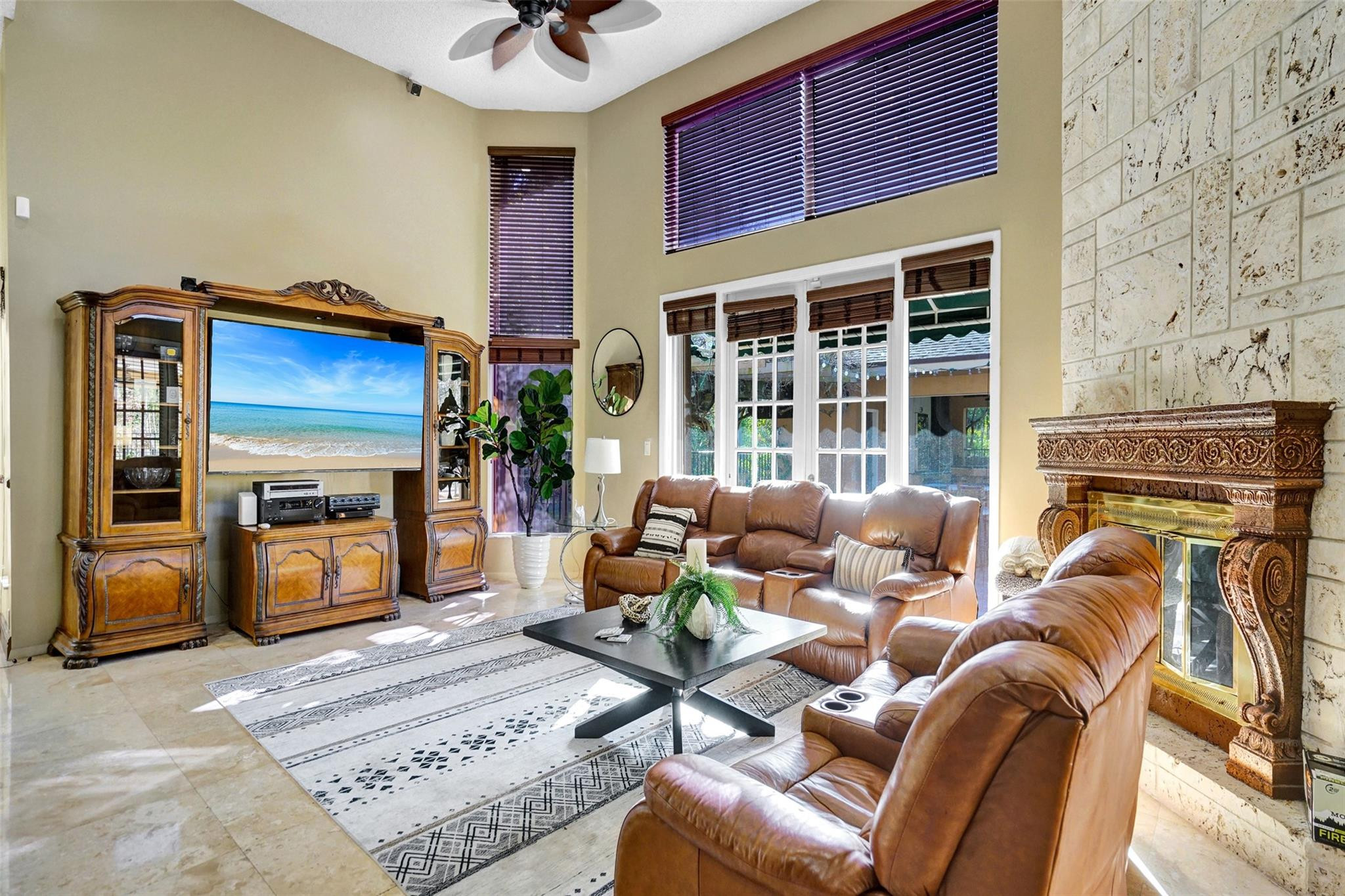 3151 Southwest 135th Terrace Davie, FL 33330 - Photo 25 of 74 a living room with furniture a fireplace and a flat screen tv