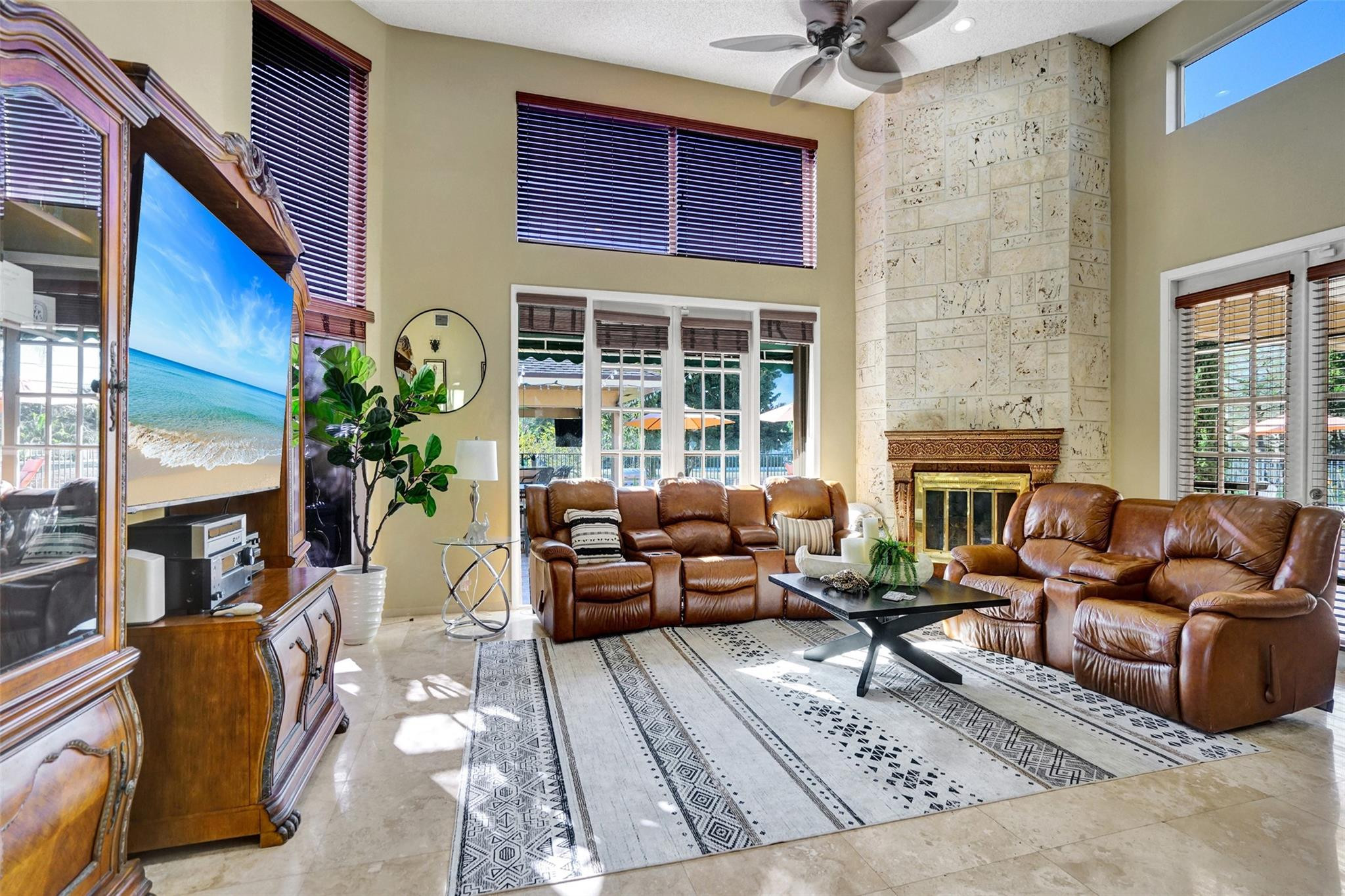 3151 Southwest 135th Terrace Davie, FL 33330 - Photo 26 of 74 a living room with furniture windows and a fireplace