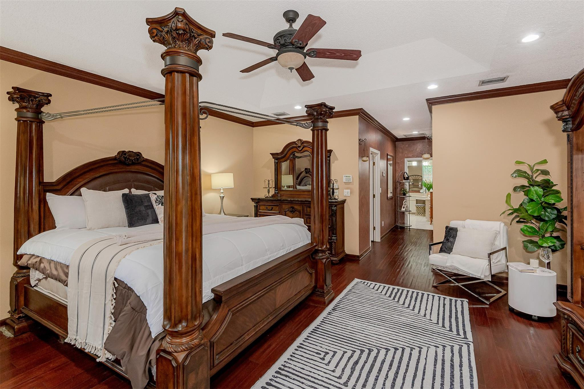 3151 Southwest 135th Terrace Davie, FL 33330 - Photo 37 of 74 a bedroom with a bed a chandelier and potted plant