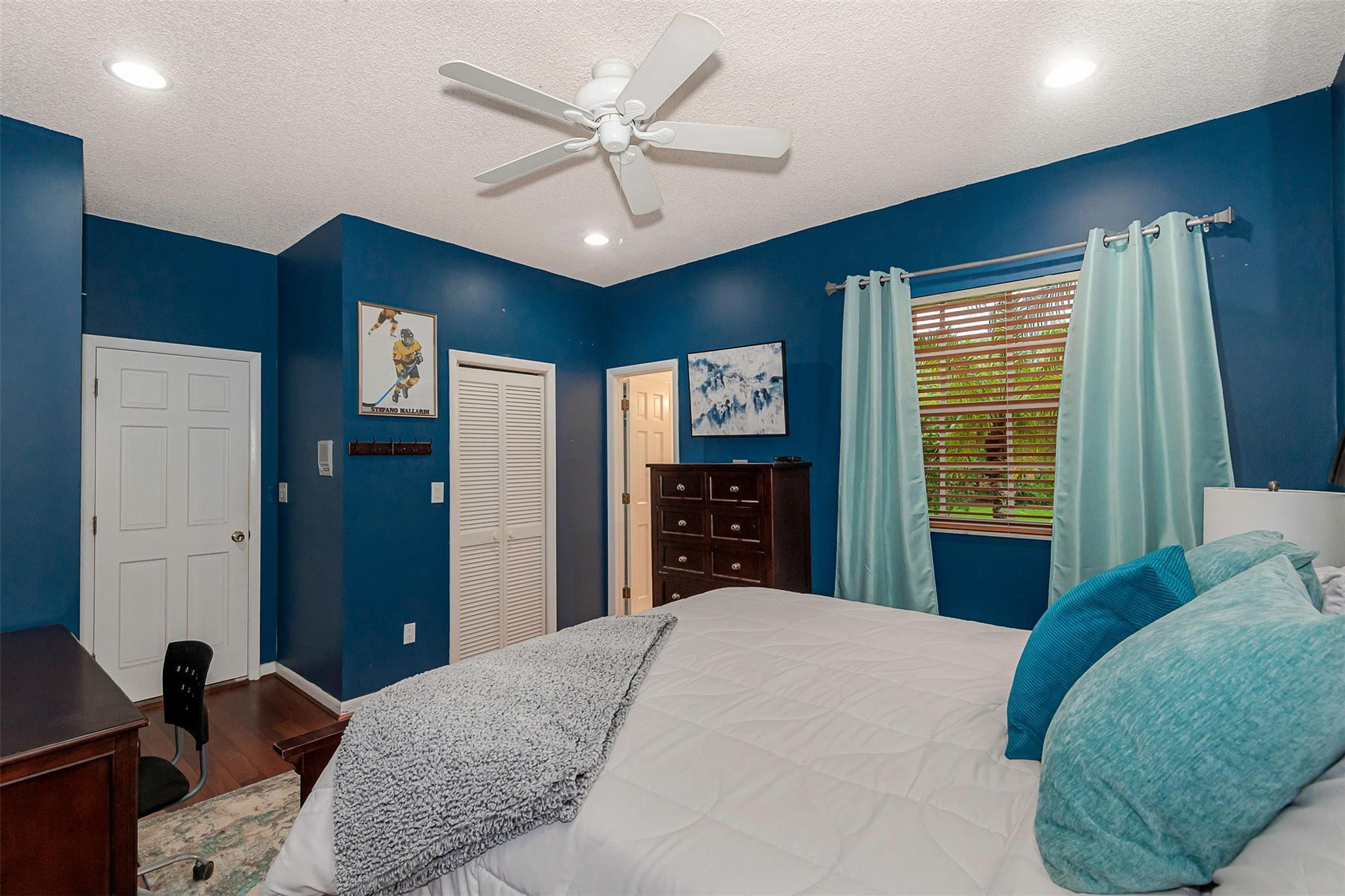 3151 Southwest 135th Terrace Davie, FL 33330 - Photo 44 of 74 a bedroom with a large bed and a chandelier