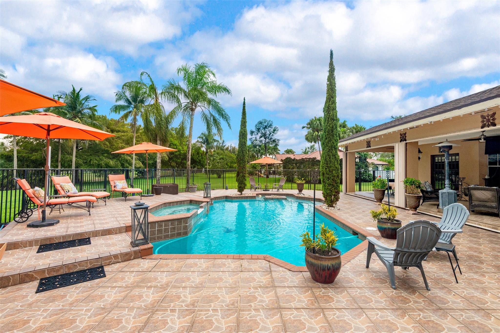 3151 Southwest 135th Terrace Davie, FL 33330 - Photo 52 of 74 a view of a swimming pool with chairs in patio