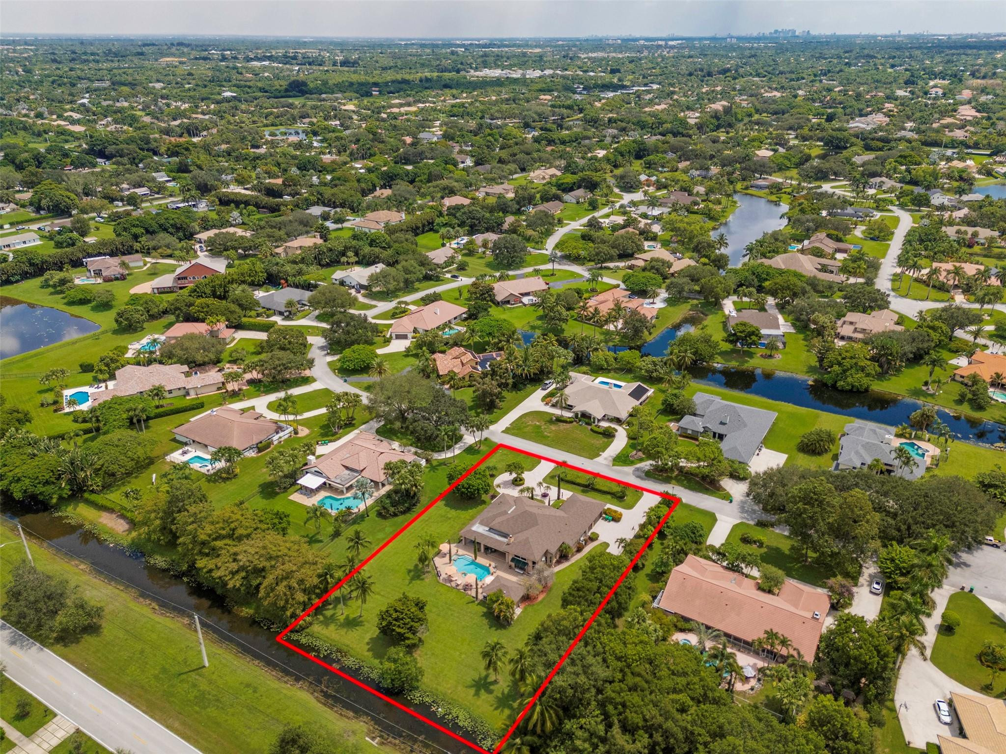 3151 Southwest 135th Terrace Davie, FL 33330 - Photo 61 of 74 an aerial view of residential houses with outdoor space and trees