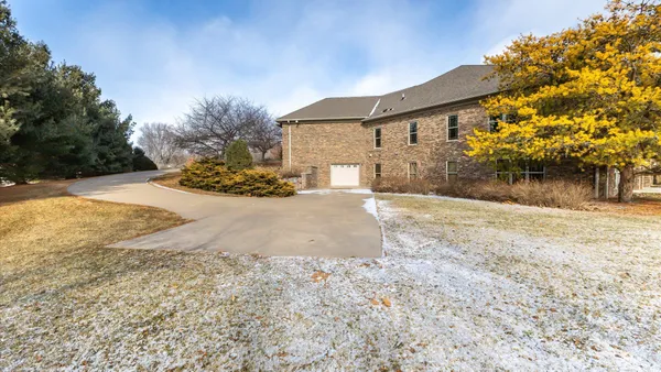 a view of a house with a snow on the road