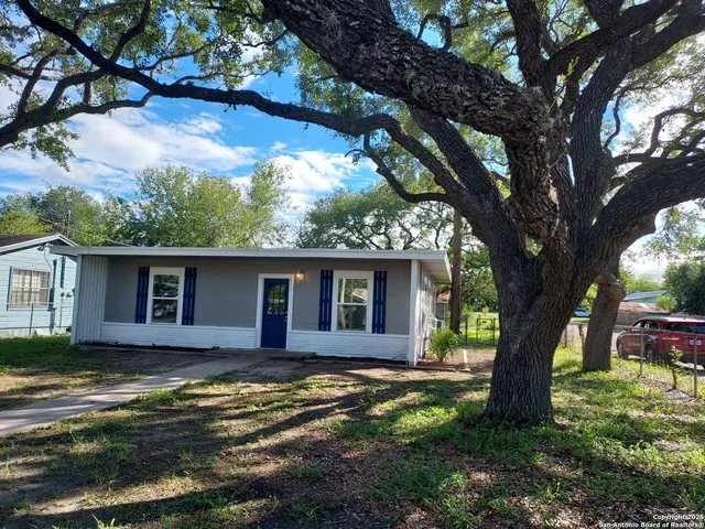 a view of a house with a yard