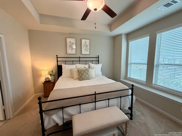 a bedroom with a bed a window and chair