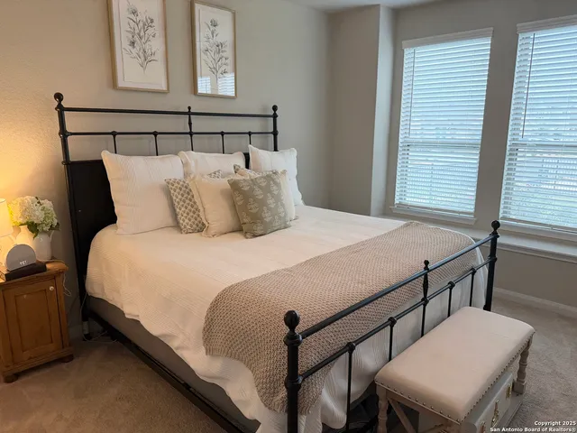 a bedroom with a bed and a table