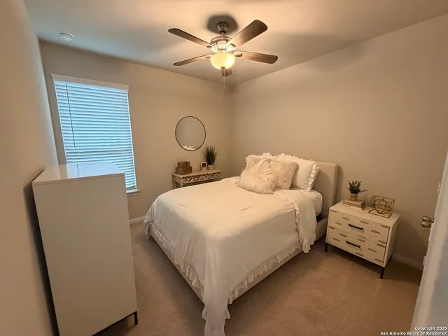 a bedroom with bed and a chandelier