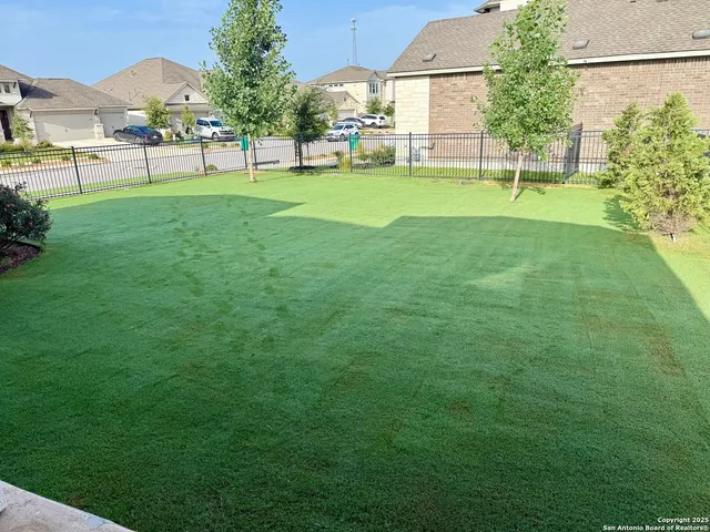 a view of a house with a backyard