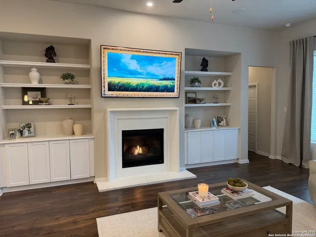 a living room with furniture flat screen tv and a fireplace