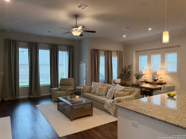 a living room with furniture and wooden floor