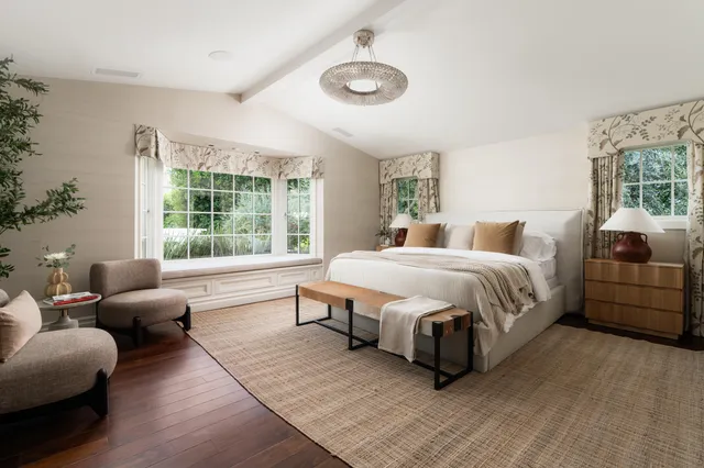 a spacious bedroom with a bed and a couch