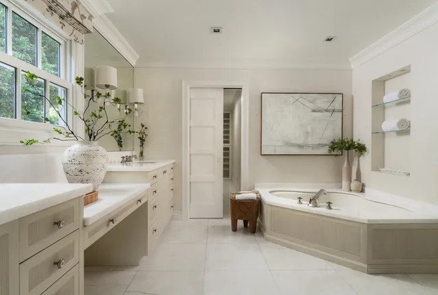 a spacious bathroom with a granite countertop sink and a mirror