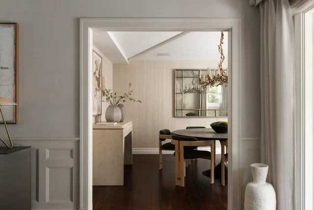 a view of a hallway with furniture and wooden floor