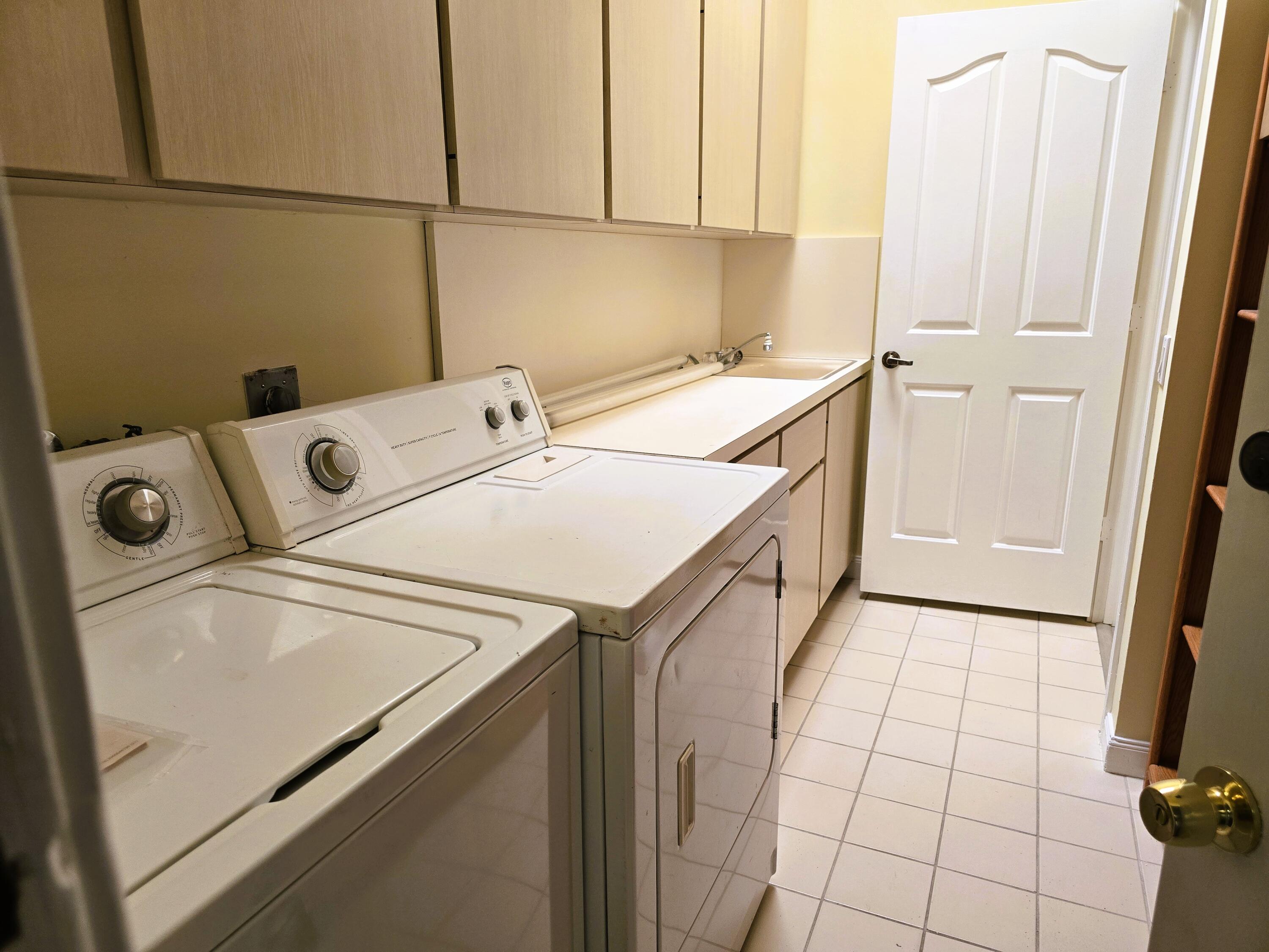 5131 Southeast Sweetbrier Terrace Hobe Sound, FL 33455 - Photo 11 of 18 a utility room with dryer and washer
