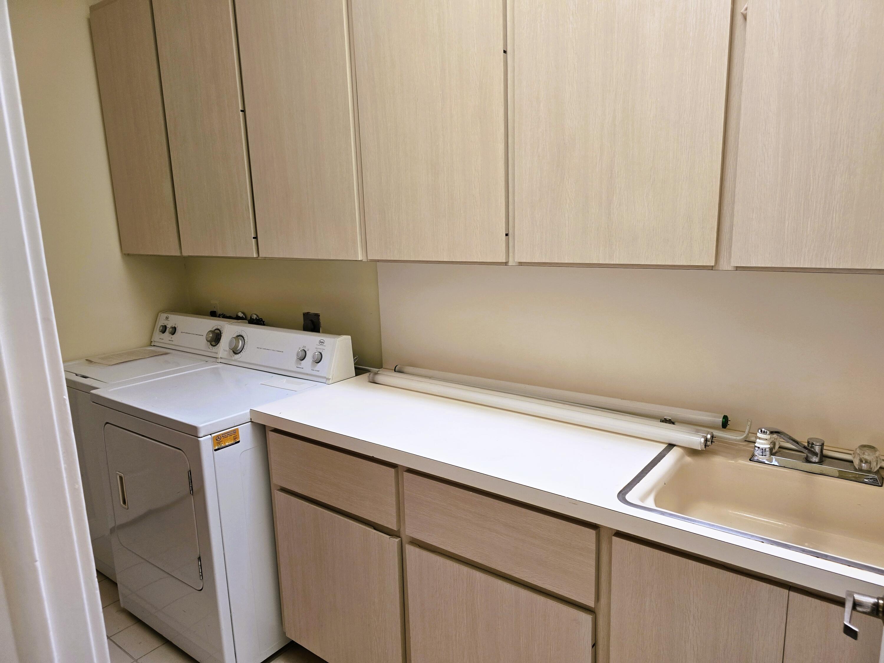 5131 Southeast Sweetbrier Terrace Hobe Sound, FL 33455 - Photo 12 of 18 a utility room with a sink