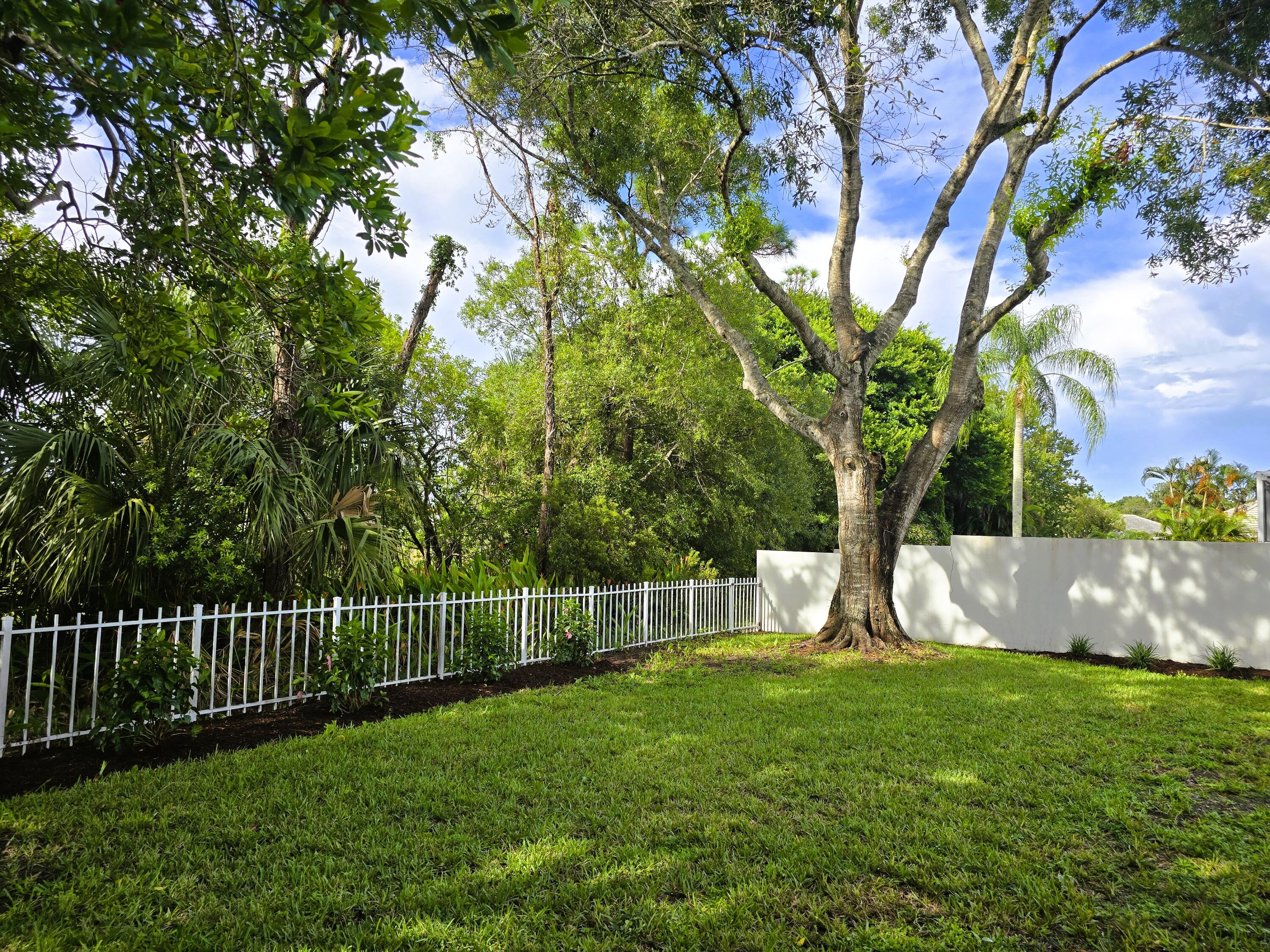 5131 Southeast Sweetbrier Terrace Hobe Sound, FL 33455 - Photo 16 of 18 a view of a yard with a large trees