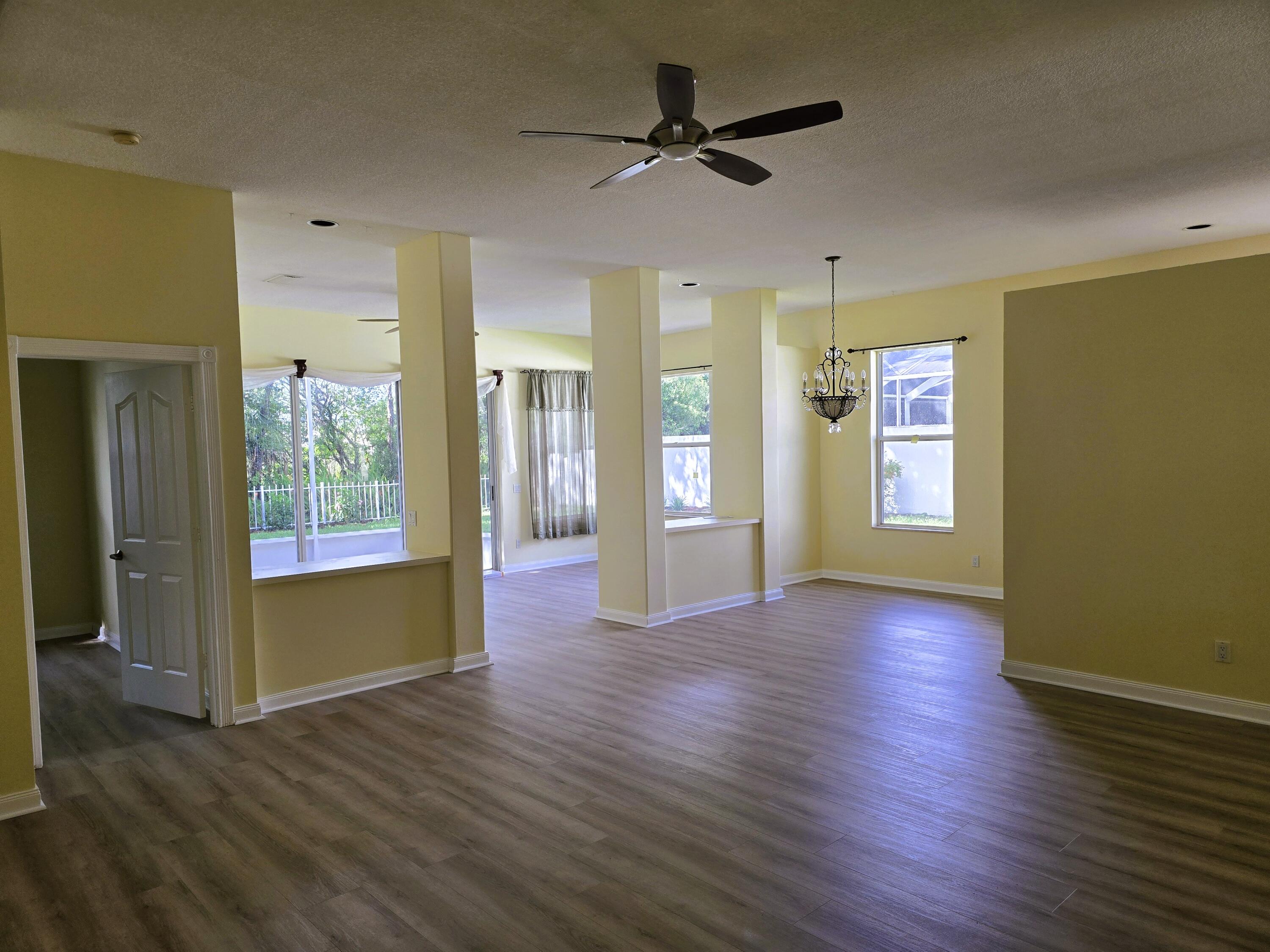 5131 Southeast Sweetbrier Terrace Hobe Sound, FL 33455 - Photo 3 of 18 a view of an empty room with window and wooden floor