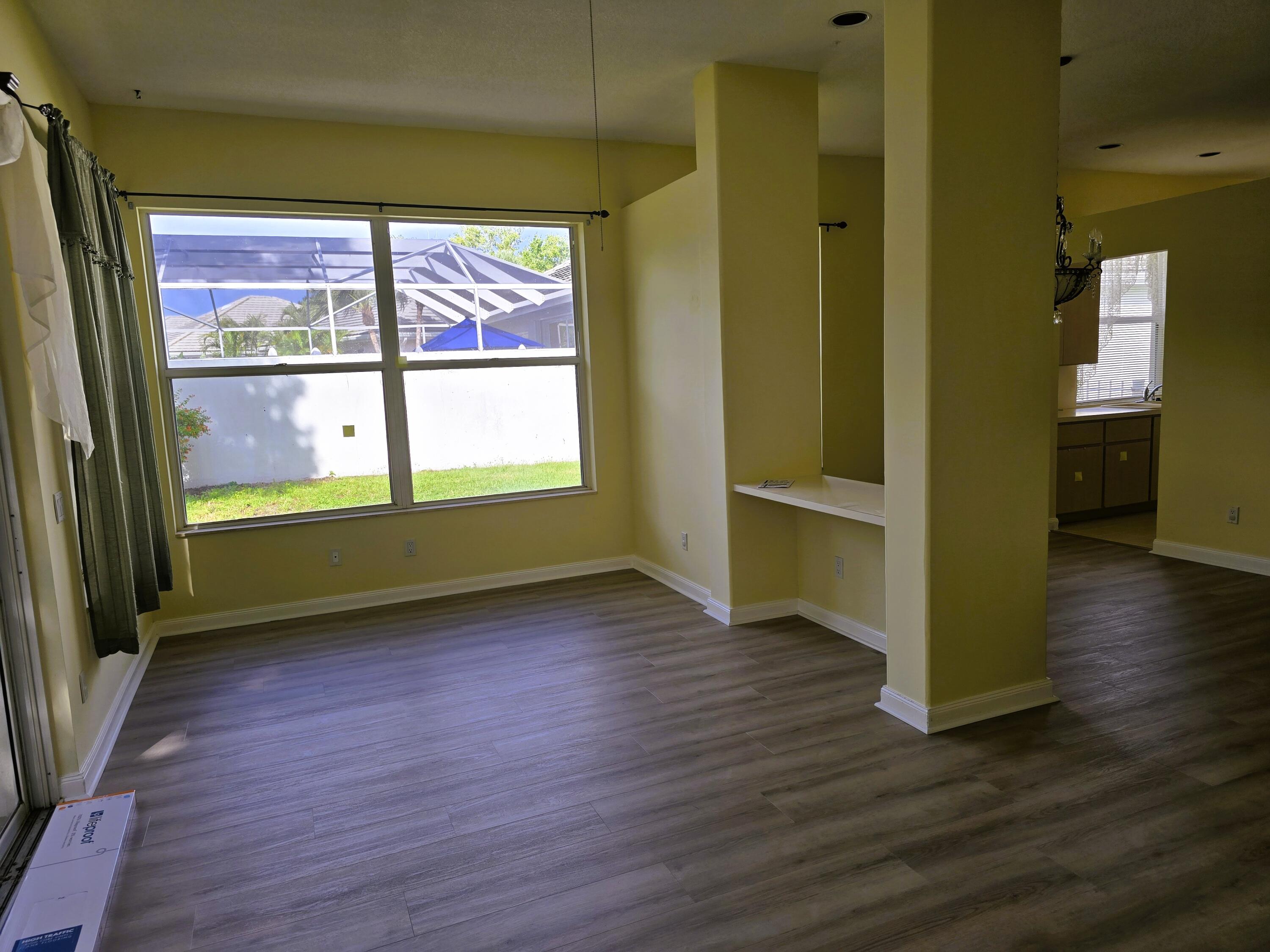 5131 Southeast Sweetbrier Terrace Hobe Sound, FL 33455 - Photo 5 of 18 a view of an empty room with wooden floor and a window