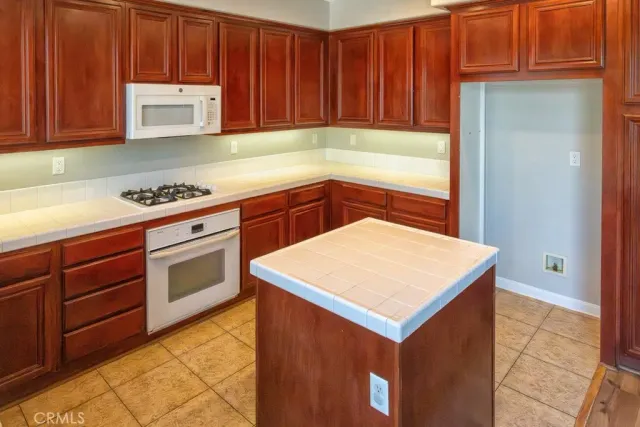 a kitchen with a sink cabinets and appliances