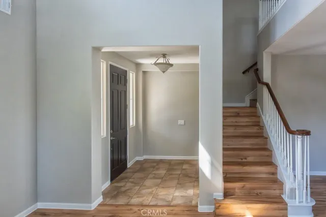 a view of a hallway view with wooden floor and staircase