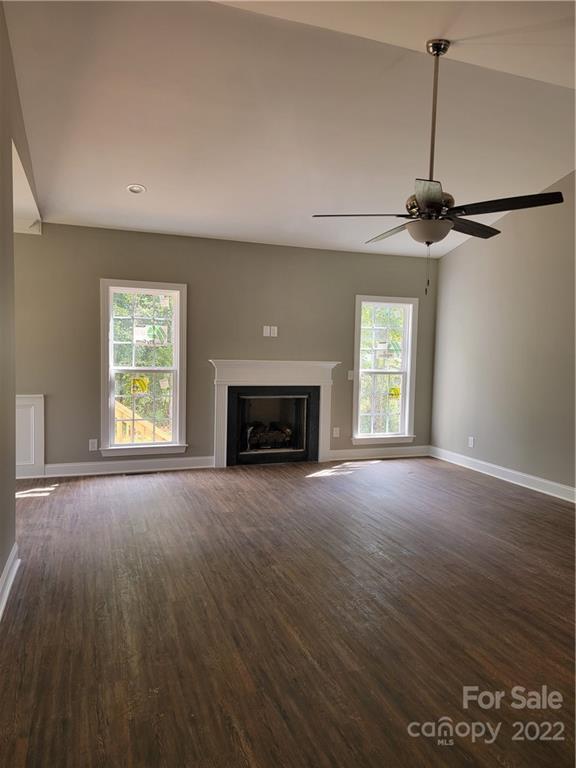970 Miles Road Dallas, NC 28034 - Photo 4 of 15 an empty room with windows and fireplace