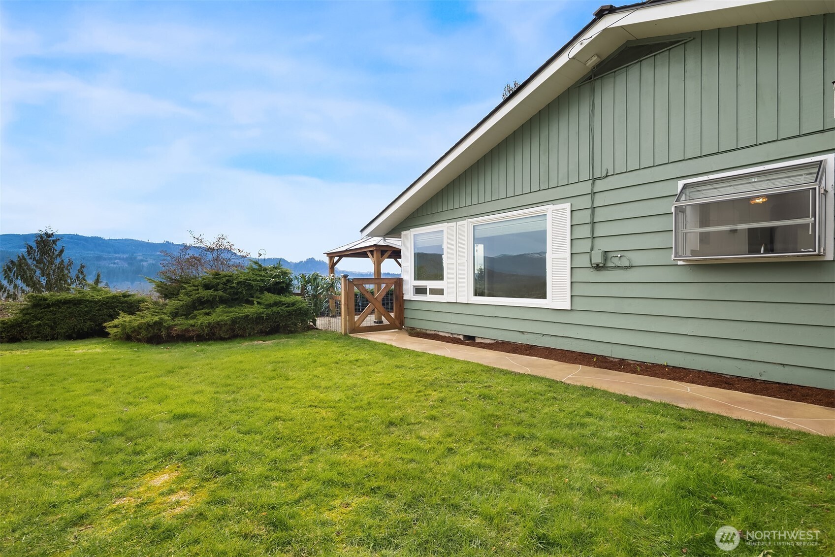 103 West Rivmont Drive Monroe, WA 98272 - Photo 28 of 34 a backyard of a house with lots of green space