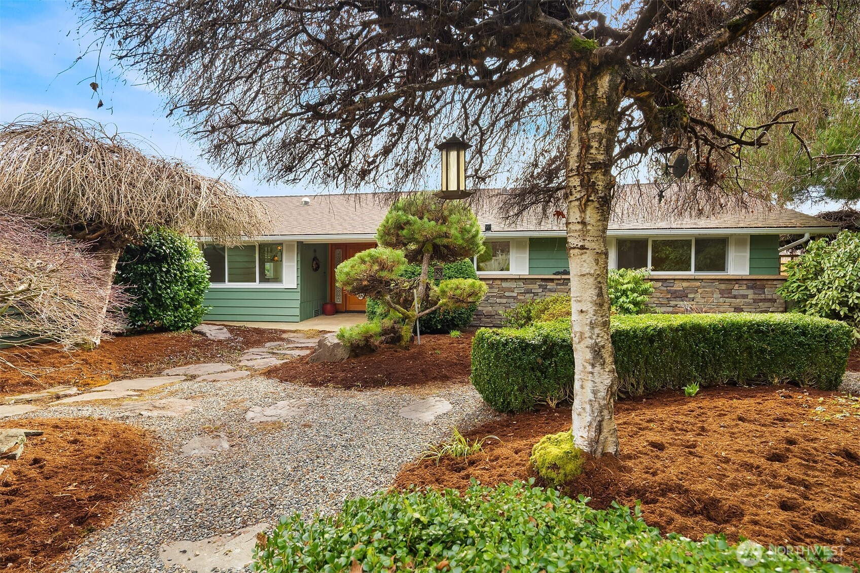 103 West Rivmont Drive Monroe, WA 98272 - Photo 3 of 34 a front view of a house with a yard and potted plants
