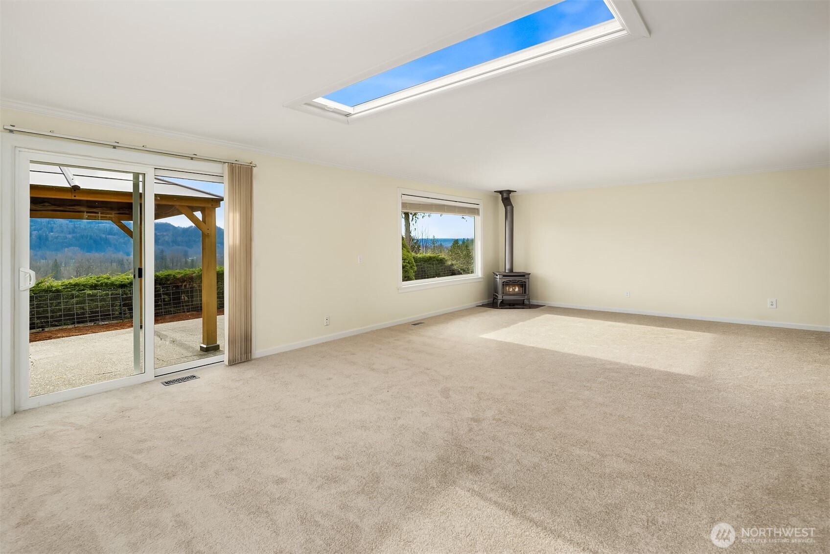 103 West Rivmont Drive Monroe, WA 98272 - Photo 8 of 34 an empty room with sliding door and wooden floor