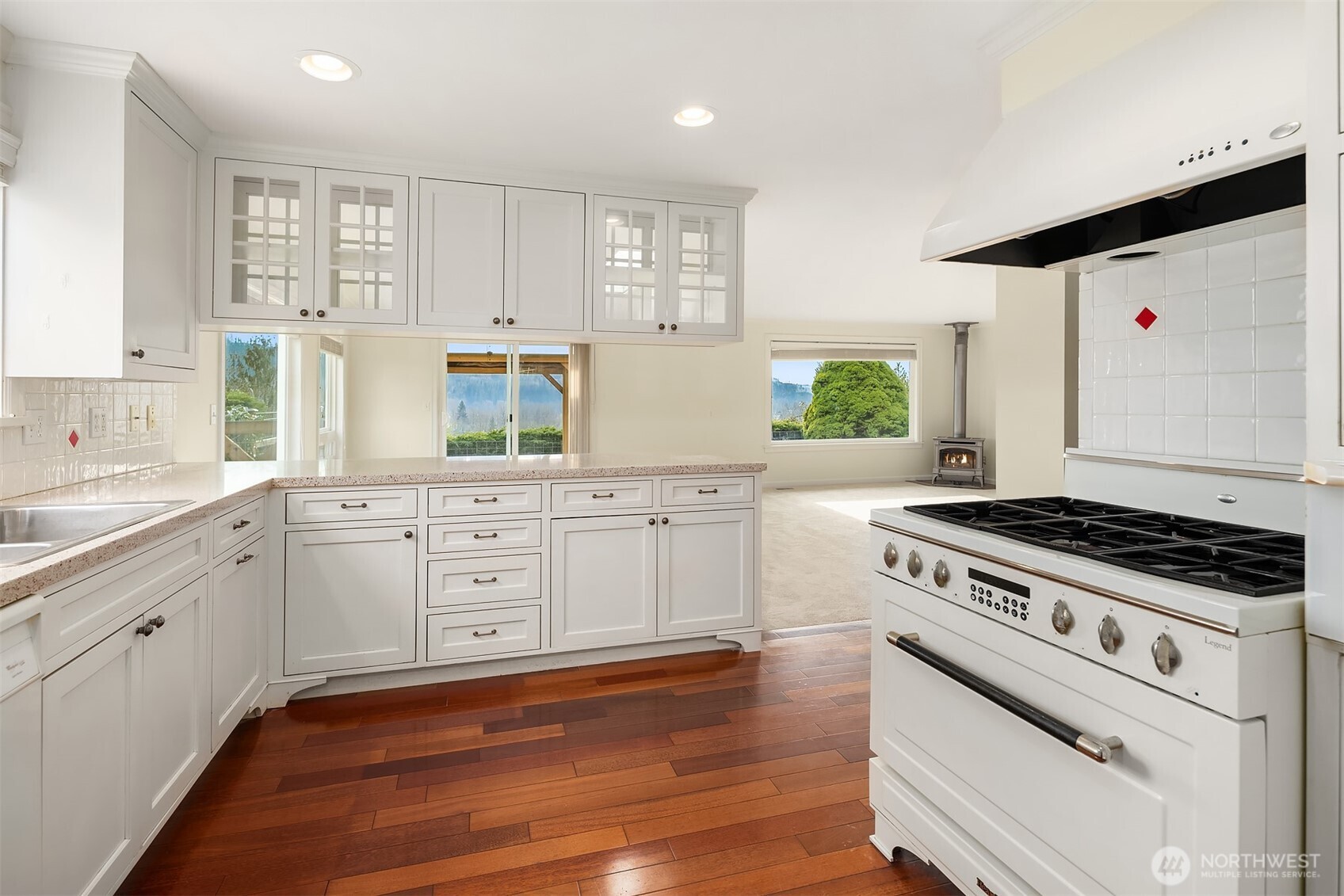103 West Rivmont Drive Monroe, WA 98272 - Photo 10 of 34 a kitchen with white cabinets and appliances