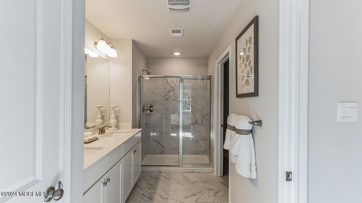 21 Victoria Gdns Square Neptune, NJ 07753 - Photo 13 of 20 a bathroom with a granite countertop sink a mirror and shower