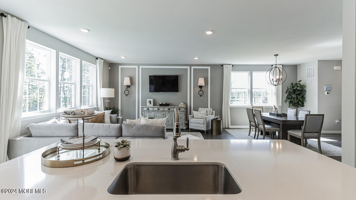 21 Victoria Gdns Square Neptune, NJ 07753 - Photo 6 of 20 a kitchen with a table chairs and couches