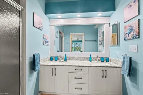 a bathroom with a sink vanity and mirror