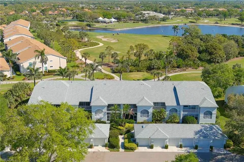 an aerial view of residential houses with outdoor space and ocean view