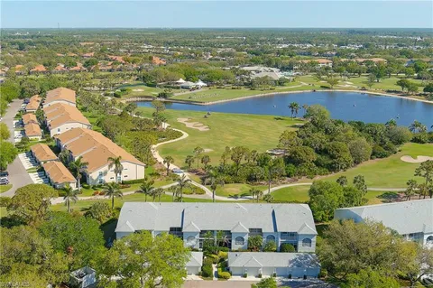 an aerial view of residential building and lake