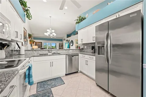 a kitchen with a sink stainless steel appliances and cabinets