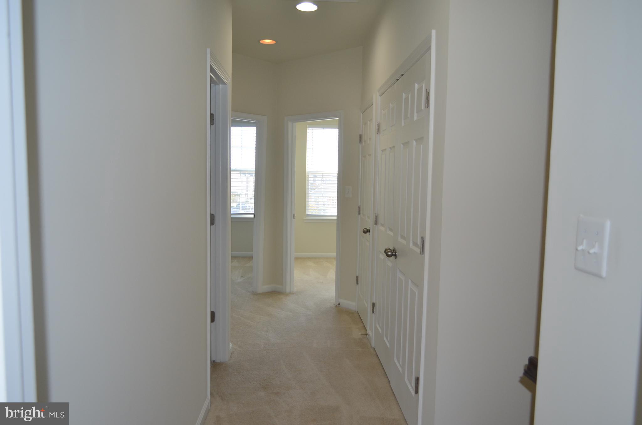 6004 Forum Frederick, MD 21703 - Photo 20 of 30 a view of a hallway with wooden floor and closet
