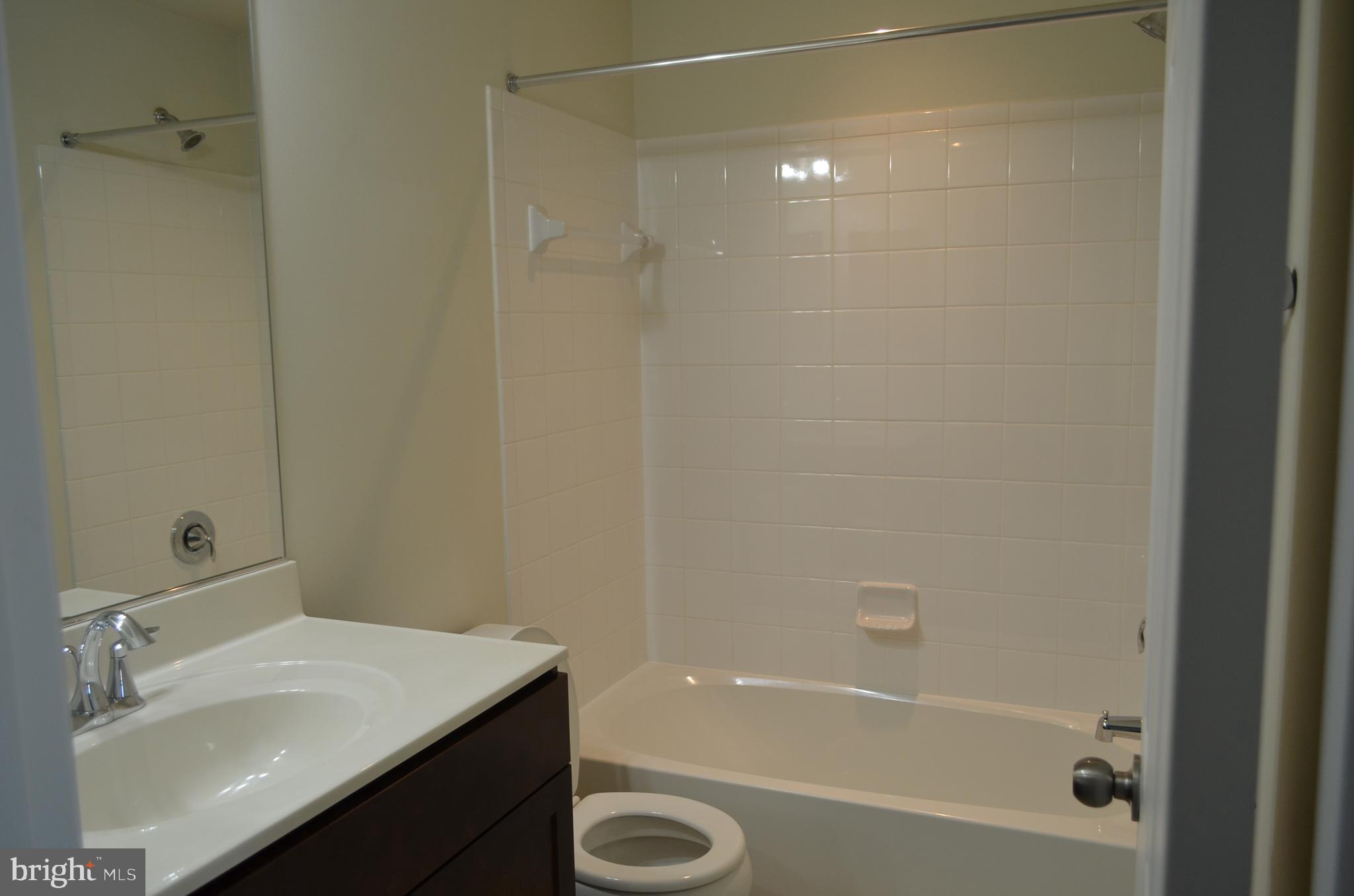 6004 Forum Frederick, MD 21703 - Photo 21 of 30 a bathroom with a sink a toilet and shower