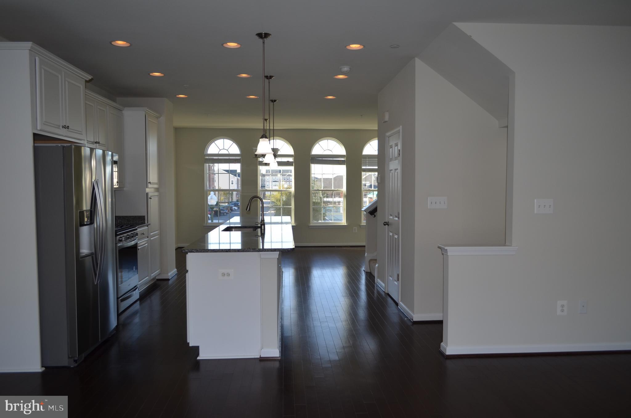 6004 Forum Frederick, MD 21703 - Photo 4 of 30 a view of entryway with kitchen and wooden floor